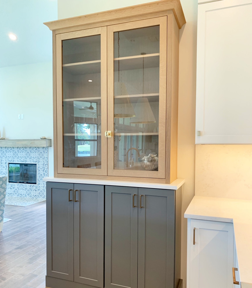 Mid-sized transitional eat-in kitchen photo with shaker cabinets, gray cabinets, quartz countertops, white backsplash, quartz backsplash, paneled appliances, an island and white countertops