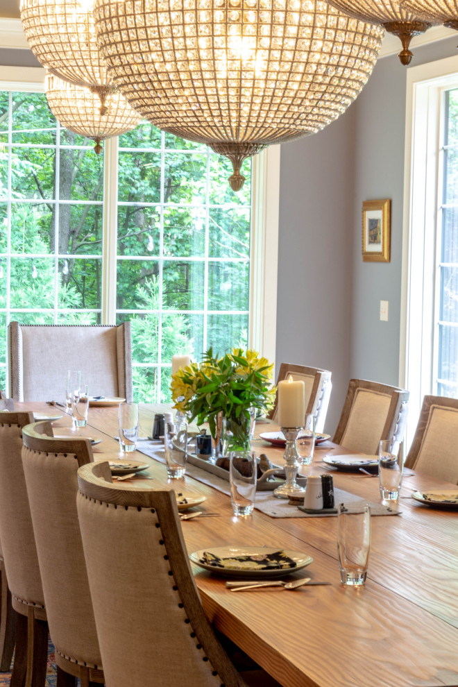 Inspiration for a large transitional medium tone wood floor, brown floor and exposed beam enclosed dining room remodel with gray walls