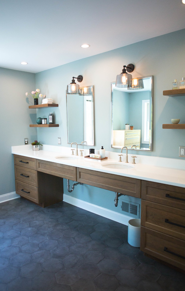 Inspiration for a mid-sized modern master bathroom in Philadelphia with recessed-panel cabinets, brown cabinets, a curbless shower, a two-piece toilet, gray tile, porcelain tile, blue walls, ceramic floors, an undermount sink, quartzite benchtops and black floor.