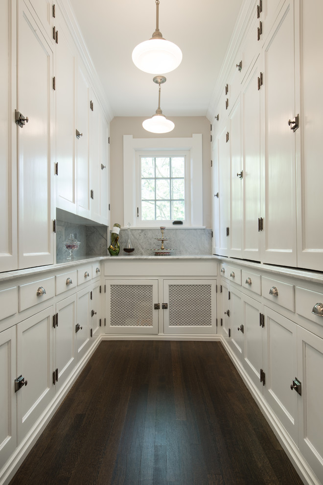 Inspiration for a large transitional u-shaped dark wood floor and brown floor kitchen pantry remodel with recessed-panel cabinets, white cabinets, gray backsplash, marble countertops, marble backsplash and no island