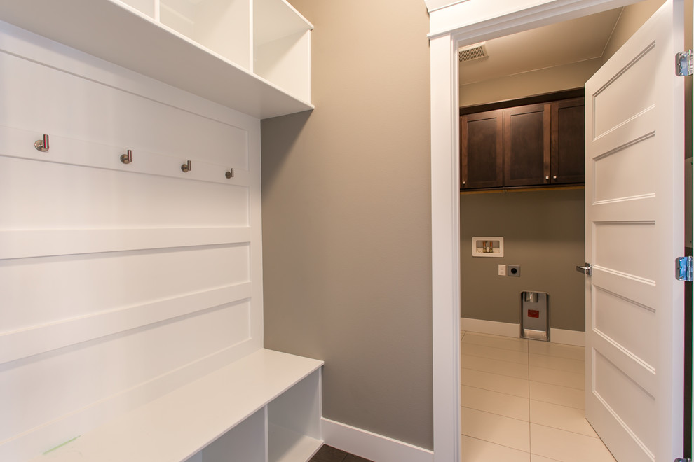 Mudroom - small transitional medium tone wood floor mudroom idea in Seattle with gray walls