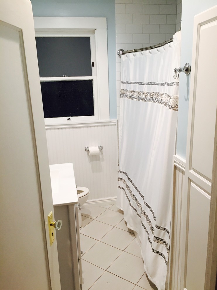 This is an example of a small contemporary master bathroom in Tampa with white cabinets, a drop-in tub, a shower/bathtub combo, white tile, ceramic tile, white walls and ceramic floors.