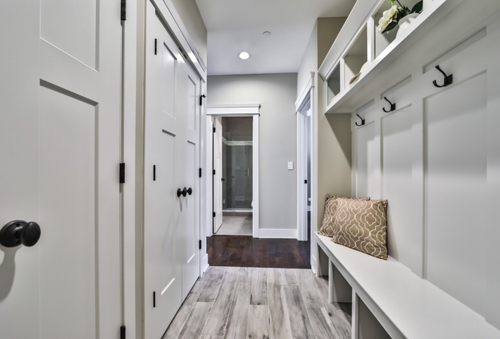 Inspiration for a mid-sized transitional medium tone wood floor and gray floor mudroom remodel in Chicago with gray walls