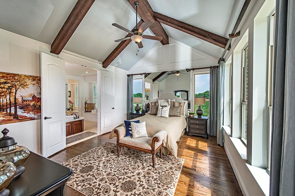 Inspiration for a traditional master bedroom in Dallas with white walls and dark hardwood floors.