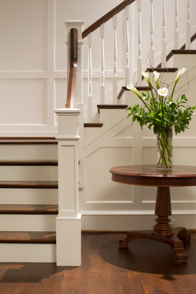 Photo of an expansive traditional wood l-shaped staircase in Baltimore with wood risers.