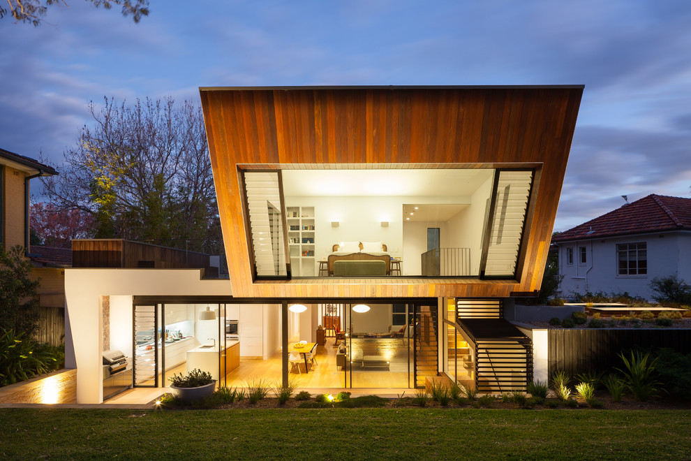 Inspiration for a contemporary two-storey exterior in Sydney with wood siding.