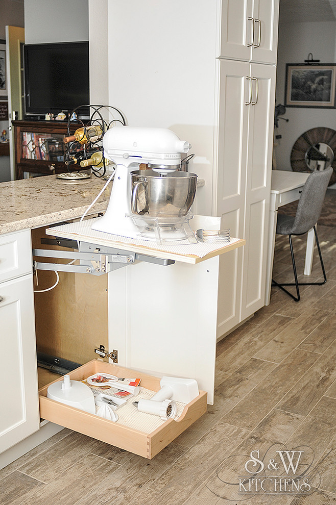 Mid-sized transitional galley porcelain tile eat-in kitchen photo in Tampa with a farmhouse sink, flat-panel cabinets, white cabinets, quartz countertops, white backsplash, subway tile backsplash, stainless steel appliances and a peninsula