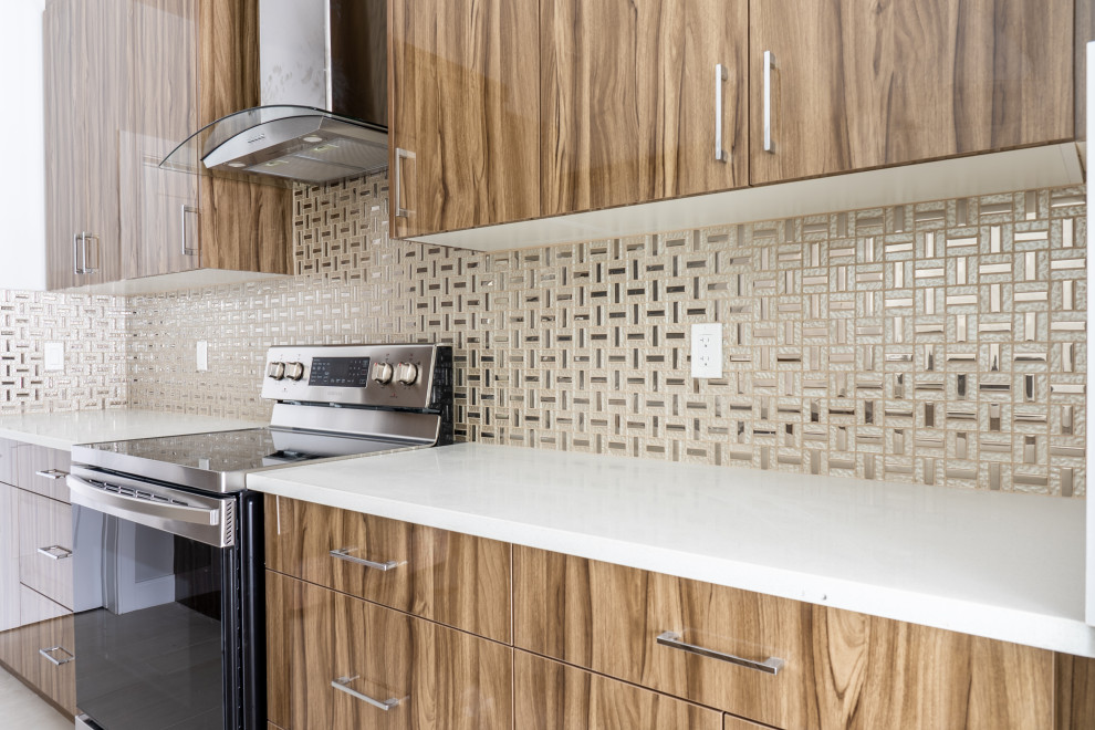 Example of a mid-sized trendy porcelain tile and gray floor eat-in kitchen design in Edmonton with a double-bowl sink, flat-panel cabinets, light wood cabinets, metallic backsplash, stainless steel appliances, an island and white countertops