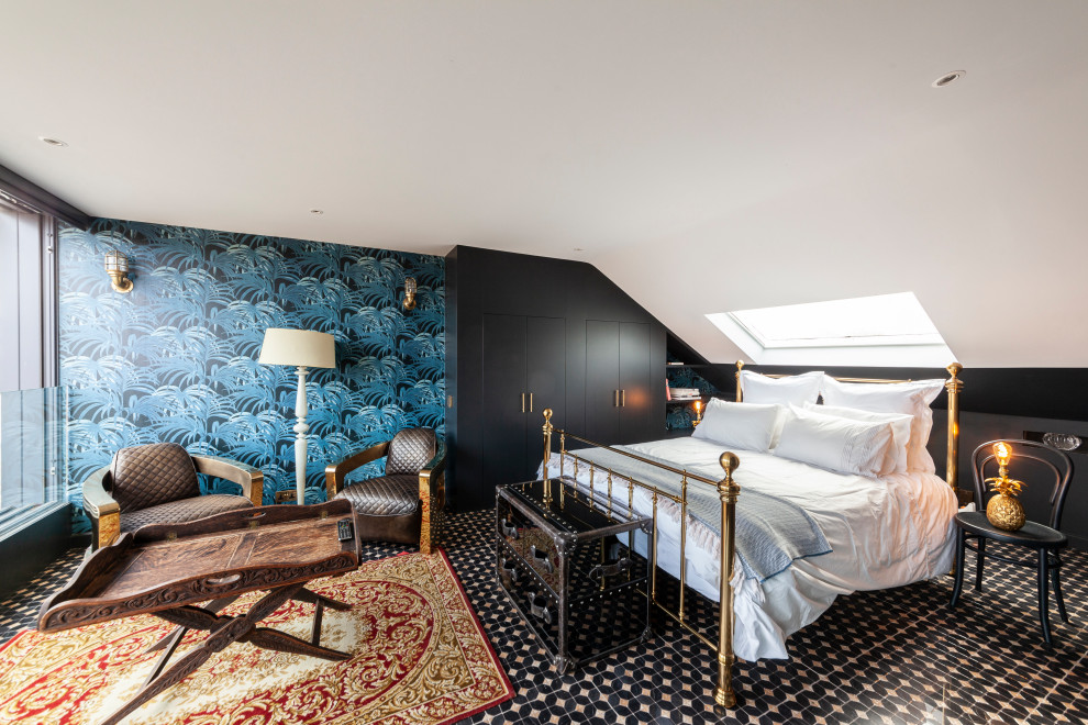 Design ideas for an expansive eclectic guest loft bedroom in London with blue walls, ceramic flooring and wallpapered walls.