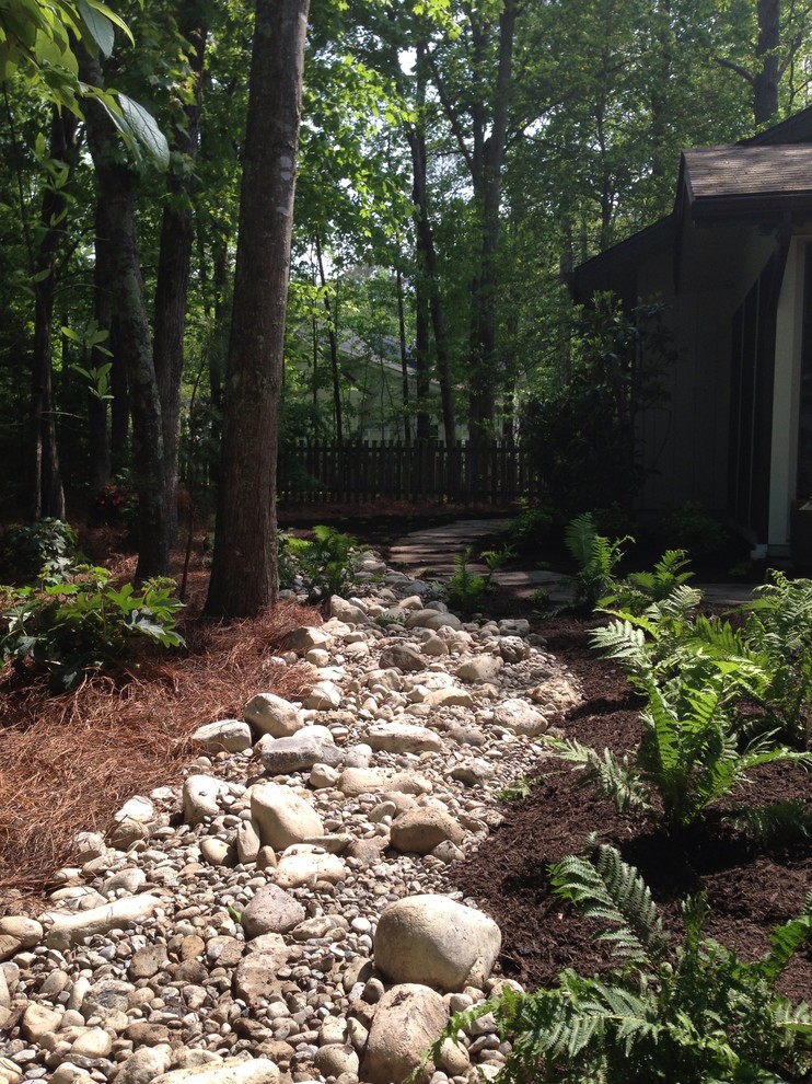 This is an example of a small transitional drought-tolerant and partial sun backyard gravel garden path for fall.