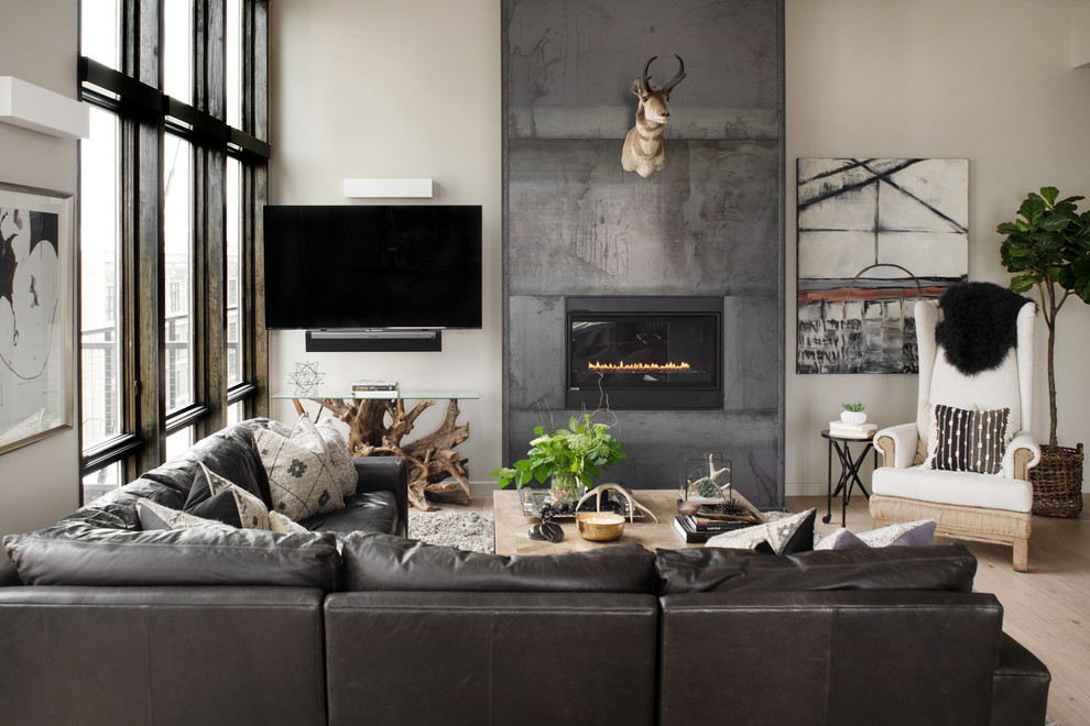 Inspiration for a mid-sized contemporary loft-style living room in Boise with beige walls, light hardwood floors, a standard fireplace and a metal fireplace surround.