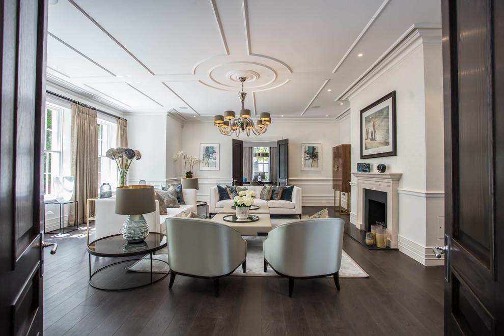 Inspiration for a transitional formal enclosed living room in Surrey with white walls, dark hardwood floors, a standard fireplace, no tv and brown floor.