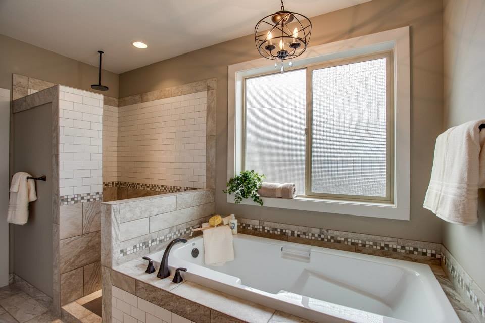 Inspiration for a traditional master bathroom in Seattle with a drop-in tub, an open shower, gray tile, porcelain tile, grey walls, porcelain floors, granite benchtops and an open shower.