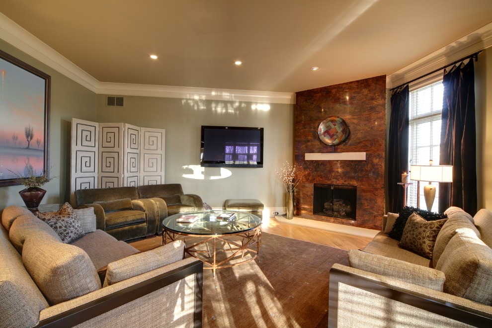 This is an example of a transitional living room in Other with a corner fireplace, a metal fireplace surround and a wall-mounted tv.