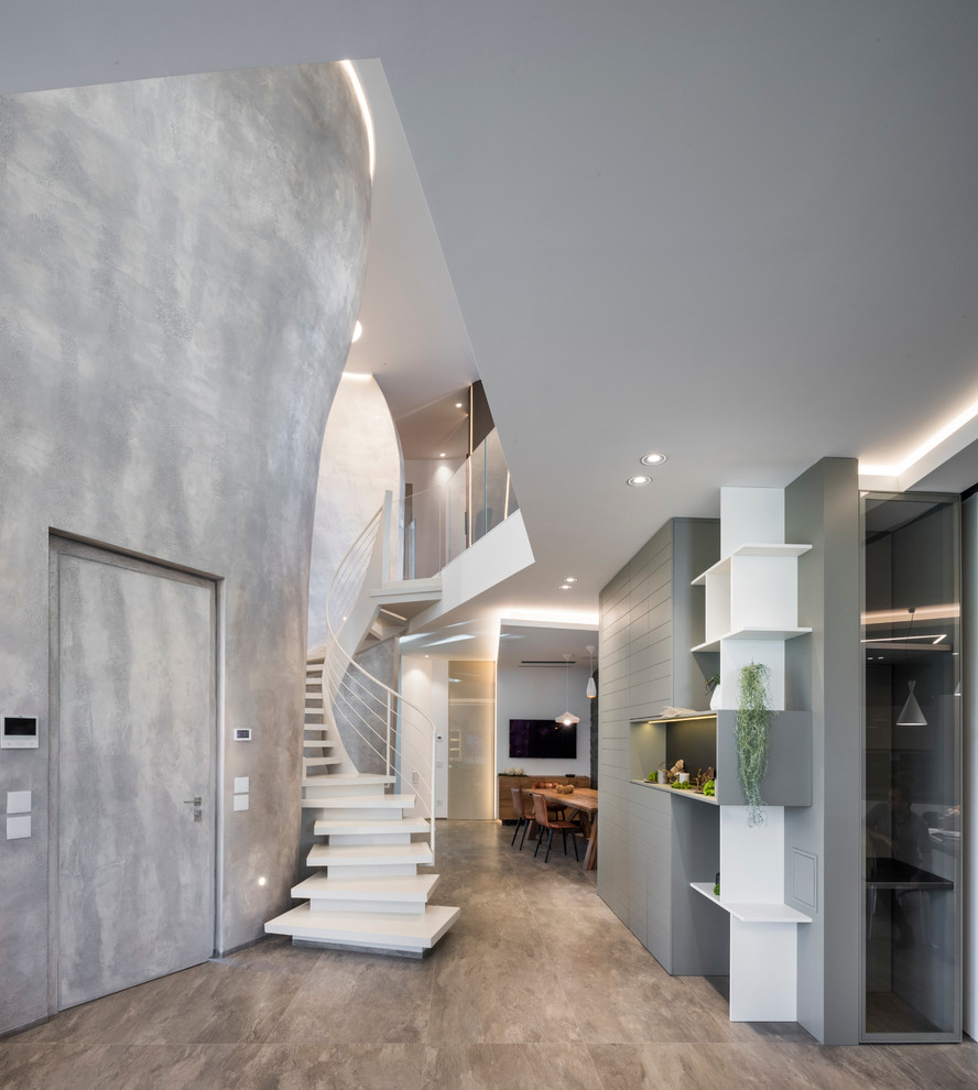 Contemporary curved staircase in Catania-Palermo with metal railing.