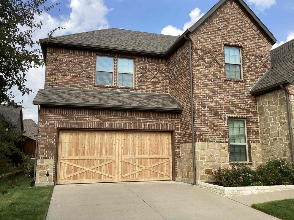 Design ideas for a large traditional attached double garage in Dallas.