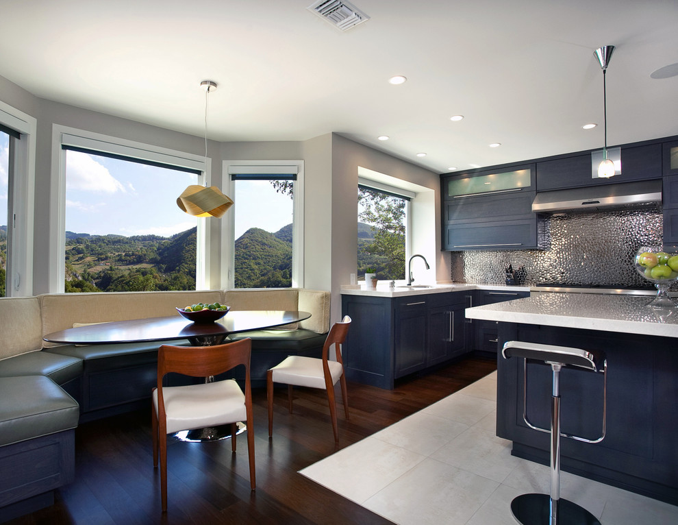 Design ideas for a contemporary eat-in kitchen in Orange County with shaker cabinets, black cabinets and metallic splashback.