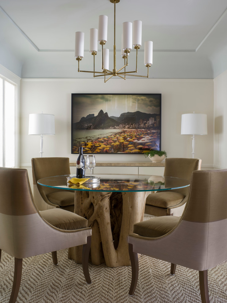 This is an example of a contemporary dining room in San Francisco with beige walls and carpet.