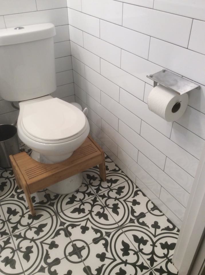 Photo of a small contemporary bathroom in Dallas with white cabinets, an open shower, a two-piece toilet, white tile, porcelain tile, grey walls, cement tiles, a pedestal sink, multi-coloured floor, a shower curtain and white benchtops.