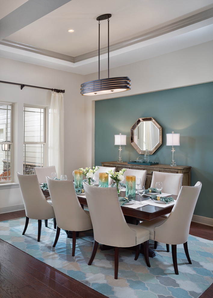 Photo of a large transitional separate dining room in Tampa with blue walls and medium hardwood floors.