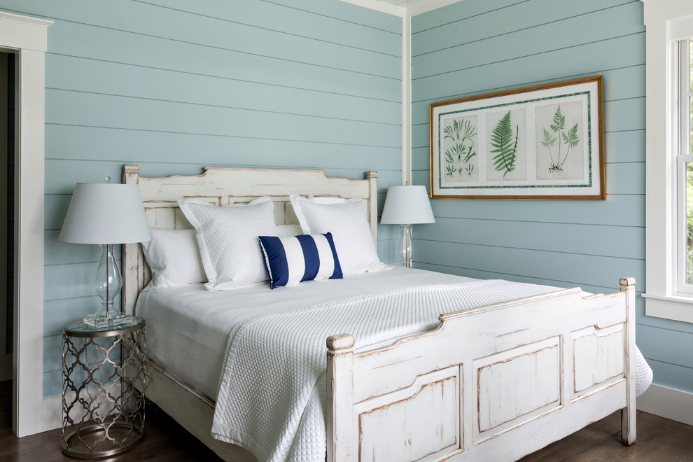 This is an example of a beach style bedroom in Boston with blue walls and dark hardwood floors.