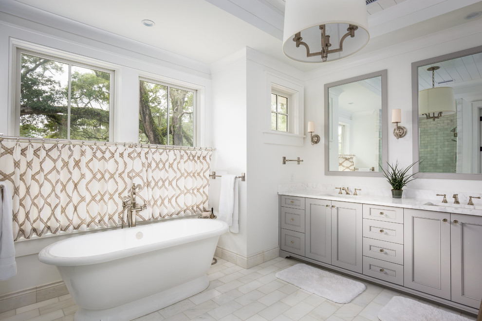 Photo of a traditional master bathroom in Charleston with grey cabinets, a freestanding tub, white walls, an undermount sink and recessed-panel cabinets.