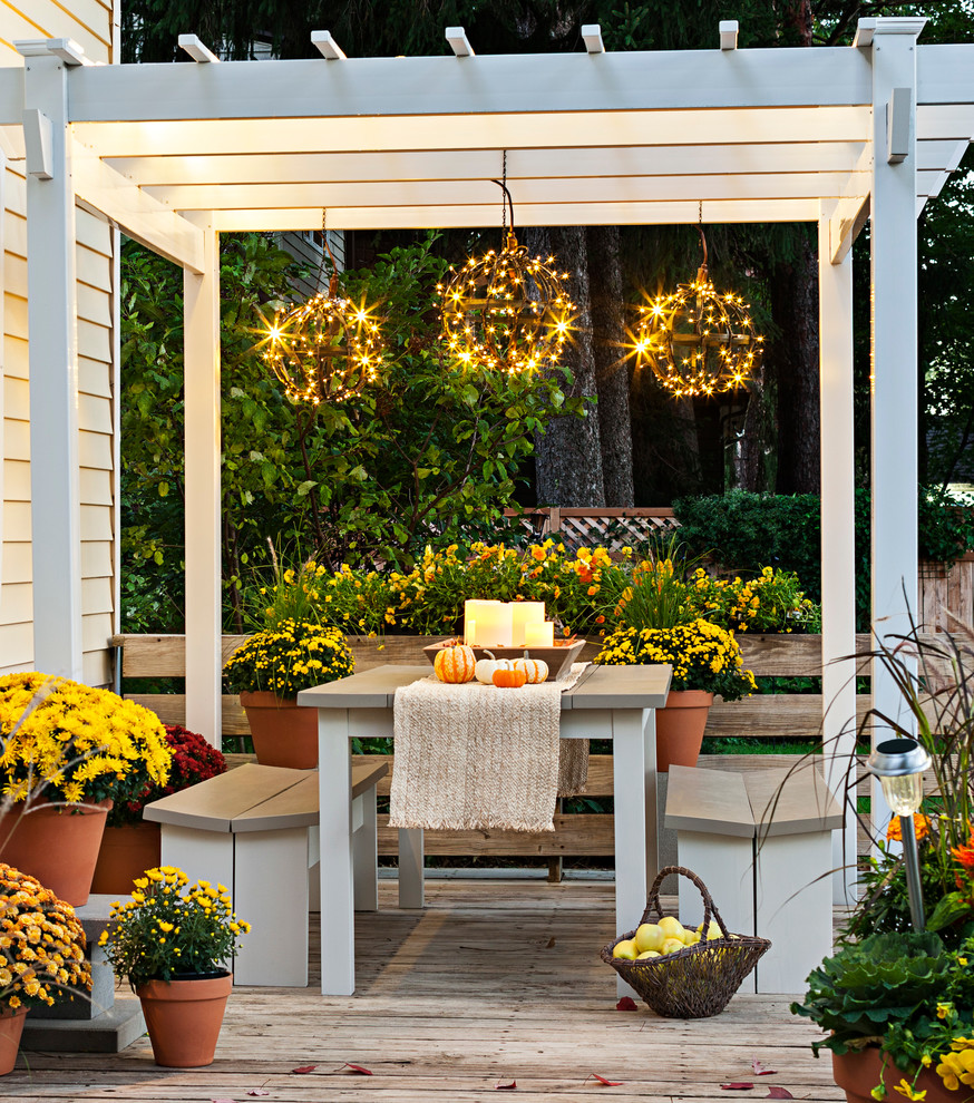 Inspiration for a mid-sized transitional backyard deck remodel in Charlotte with a pergola