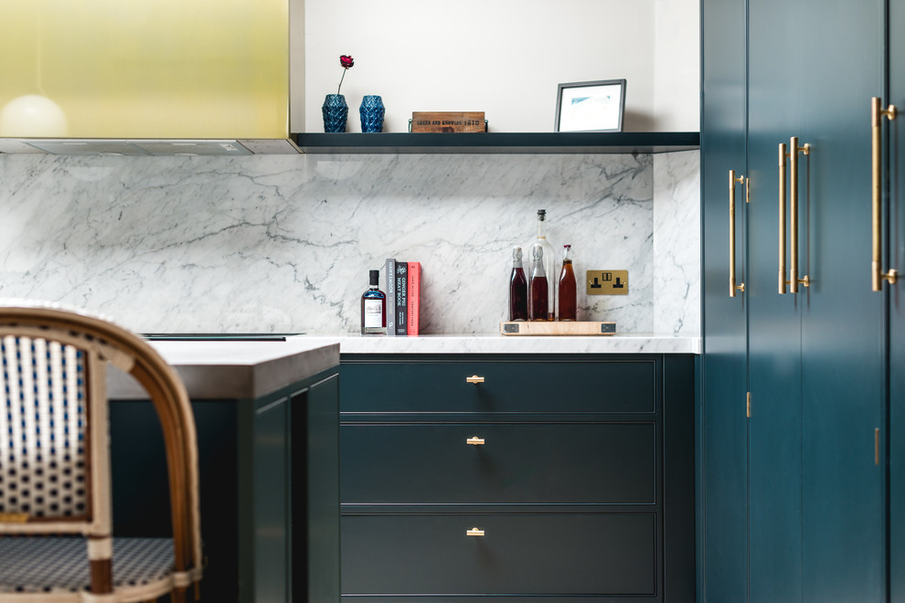 Inspiration for a large transitional l-shaped open plan kitchen in London with an integrated sink, flat-panel cabinets, blue cabinets, concrete benchtops, grey splashback, marble splashback, stainless steel appliances, cement tiles, with island and beige floor.