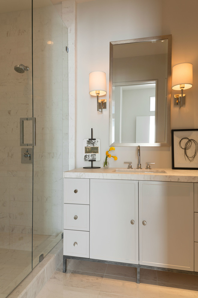 Design ideas for a large modern master bathroom in Dallas with an undermount sink, recessed-panel cabinets, white cabinets, marble benchtops, a corner shower, white tile, grey walls and marble floors.