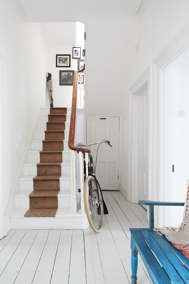 Traditional painted wood straight staircase in London with painted wood risers.