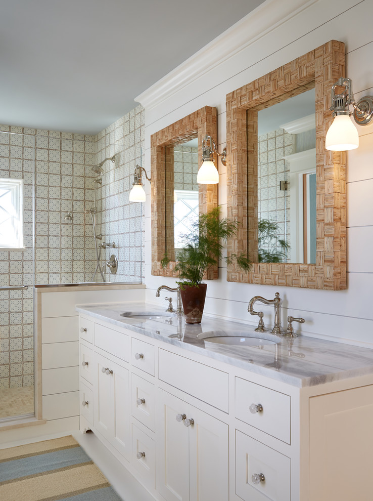 Design ideas for a beach style master bathroom in Portland Maine with white cabinets, multi-coloured tile, white walls, an undermount sink, marble benchtops, white benchtops and shaker cabinets.