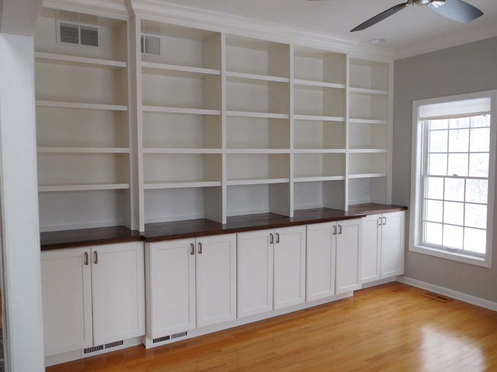 Mid-sized traditional study room in Philadelphia with grey walls, medium hardwood floors, no fireplace, brown floor and a built-in desk.