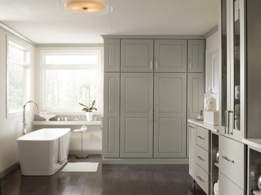 Tall Bathroom With Floor To Ceiling Cabinets And A Console Bathtub