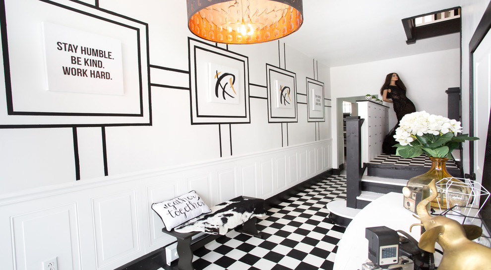 Mid-sized transitional vinyl floor and black floor entry hall photo with white walls and a black front door