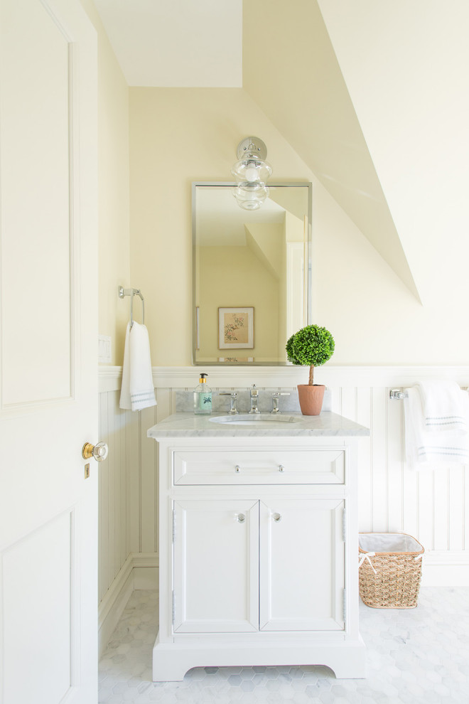 Inspiration for a timeless mosaic tile floor, white floor, single-sink and wainscoting bathroom remodel in Boston with recessed-panel cabinets, white cabinets, yellow walls, an undermount sink, gray countertops and a freestanding vanity