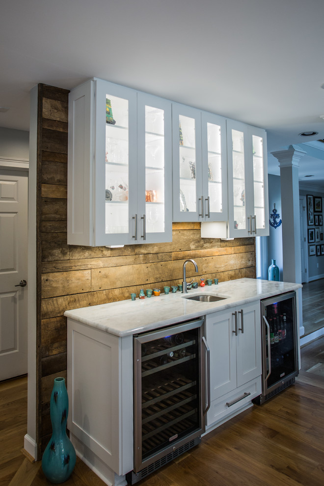 Inspiration for an expansive contemporary eat-in kitchen in Charlotte with an undermount sink, shaker cabinets, white cabinets, multi-coloured splashback, stone tile splashback, stainless steel appliances, medium hardwood floors, multiple islands and brown floor.