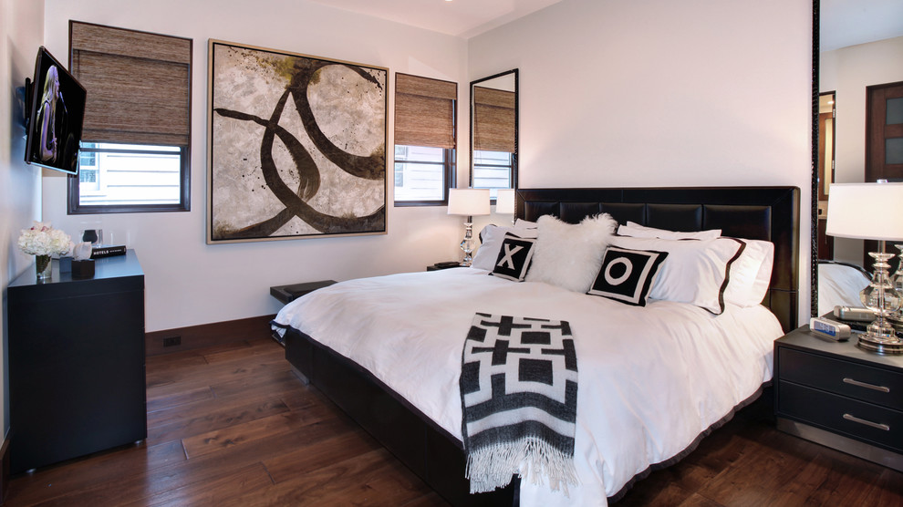 Photo of a large contemporary guest bedroom in Orange County with white walls and dark hardwood floors.