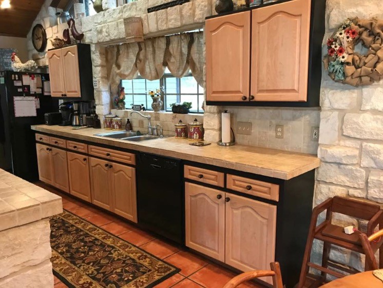 Example of a kitchen design in Austin with light wood cabinets