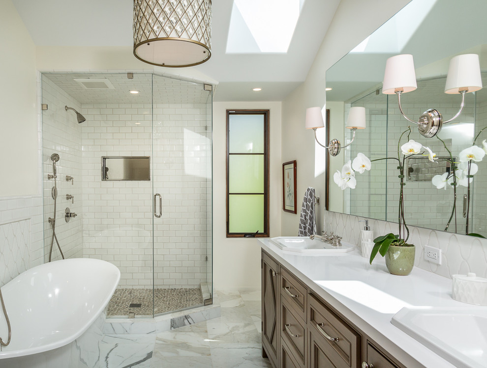 Bathroom in Los Angeles with a drop-in sink, a freestanding tub, a corner shower, white tile, subway tile and recessed-panel cabinets.