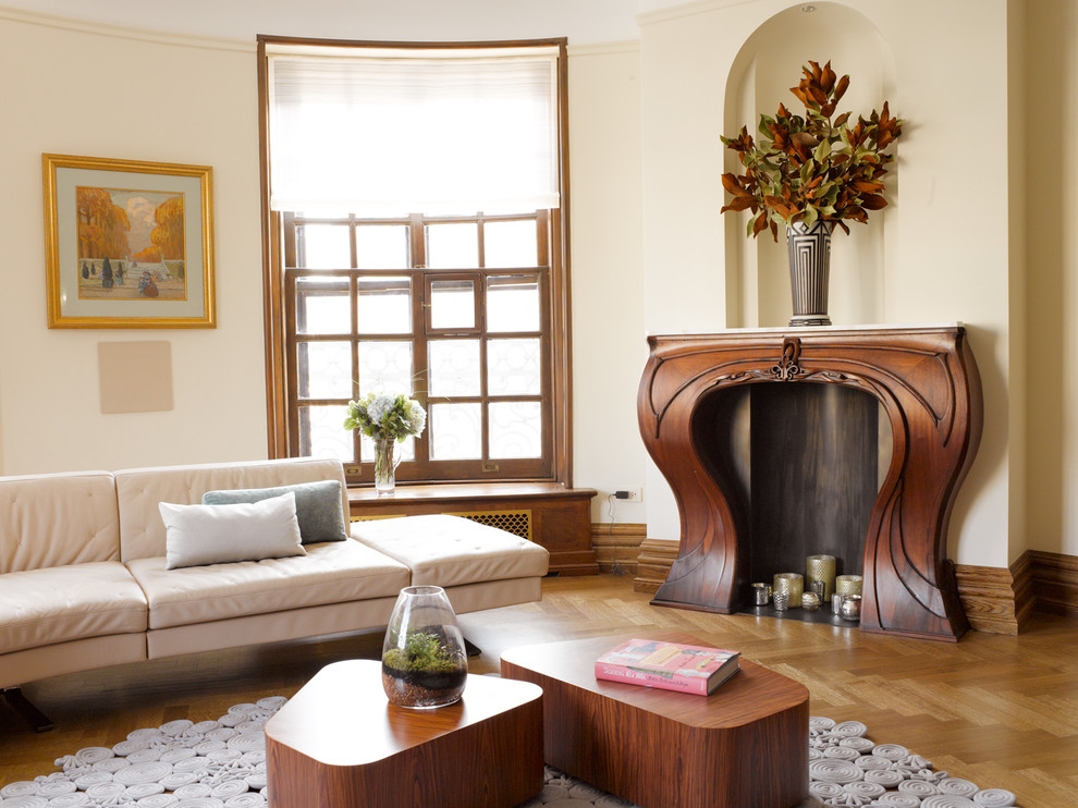 Mid-sized transitional formal and open concept medium tone wood floor living room photo in New York with beige walls, a standard fireplace, a wood fireplace surround and no tv