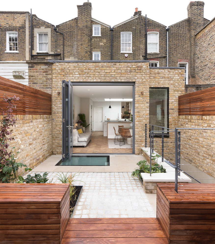Photo of a mid-sized contemporary patio in London with no cover.
