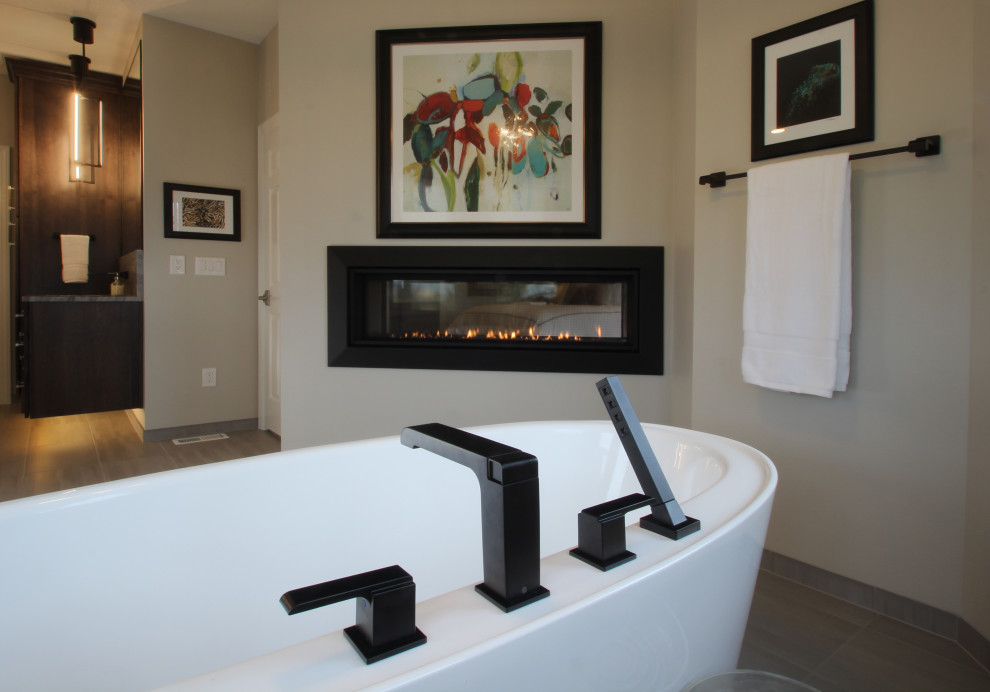 This is an example of an expansive transitional master bathroom in Other with shaker cabinets, dark wood cabinets, a freestanding tub, a corner shower, a one-piece toilet, gray tile, ceramic tile, ceramic floors, an undermount sink, quartzite benchtops, grey floor, a hinged shower door, grey benchtops, an enclosed toilet, a double vanity and a floating vanity.