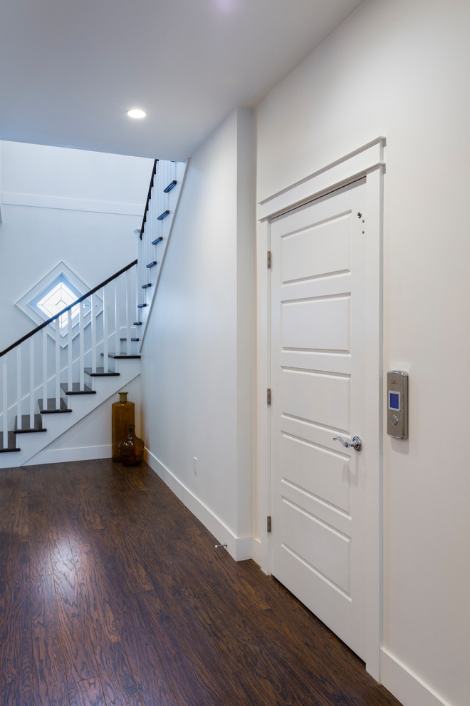 Front door - mid-sized transitional dark wood floor and brown floor front door idea in Vancouver with white walls and a black front door
