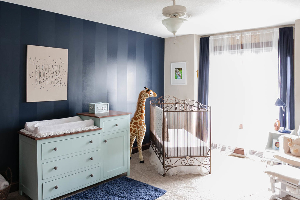 Photo of a traditional nursery for boys in Minneapolis with blue walls and carpet.