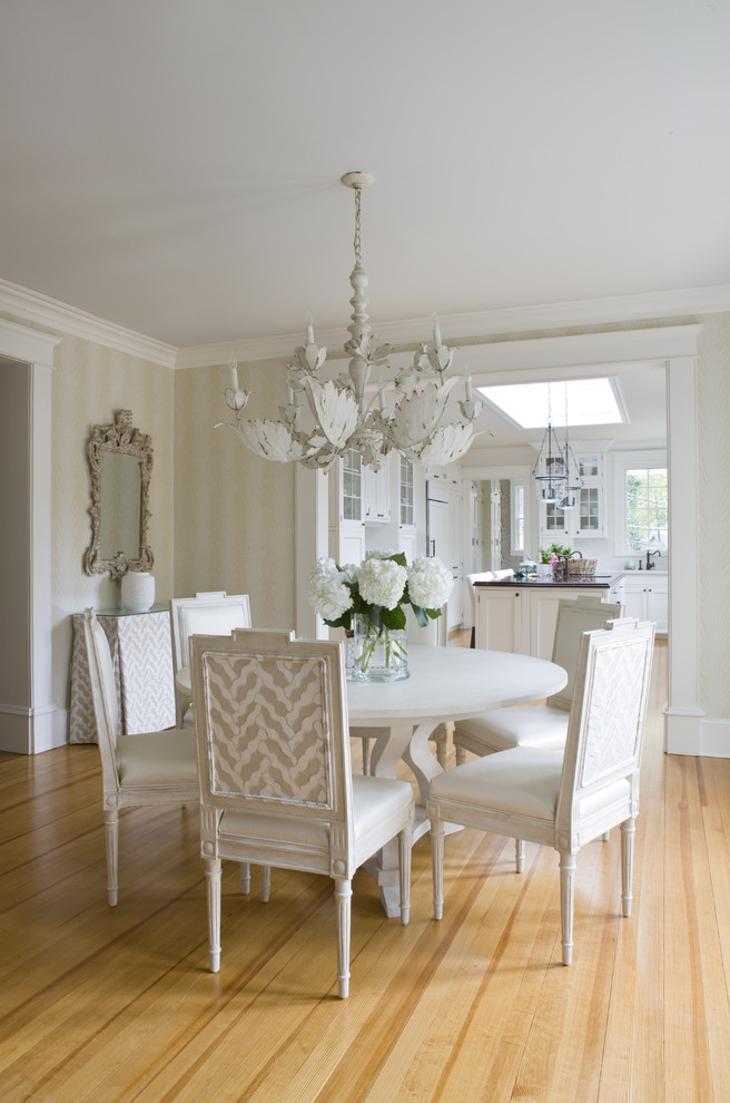 This is an example of a traditional dining room in DC Metro with beige walls and medium hardwood floors.