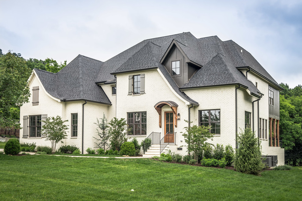 Design ideas for a traditional two-storey brick white exterior in Nashville.