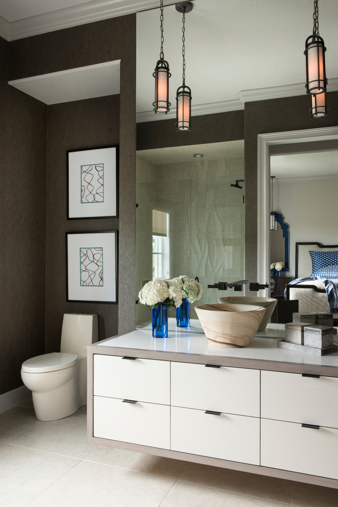Photo of a contemporary bathroom in Orlando with a vessel sink, flat-panel cabinets, white cabinets, a one-piece toilet and brown walls.