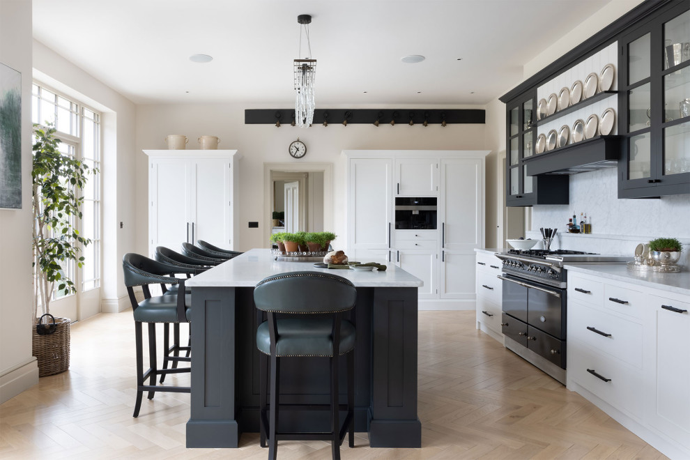 Inspiration for an expansive transitional open plan kitchen in Sussex with shaker cabinets and marble splashback.