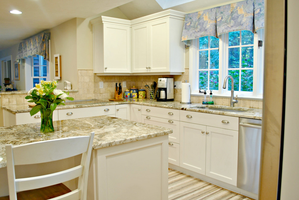 Design ideas for a mid-sized traditional u-shaped eat-in kitchen in Boston with an undermount sink, recessed-panel cabinets, white cabinets, granite benchtops, beige splashback, stainless steel appliances, medium hardwood floors and with island.