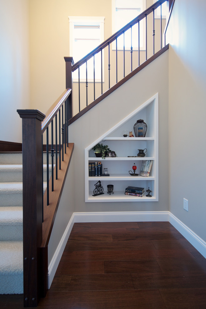 This is an example of a mid-sized traditional carpeted u-shaped staircase in Vancouver with carpet risers.